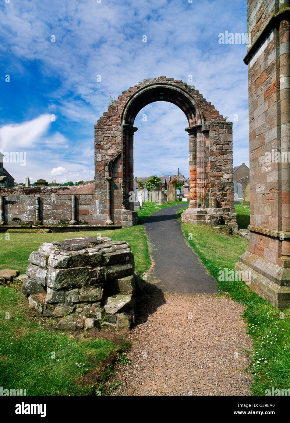 Coldingham Benedictine priory, Berwickshire, looking WNW: column base (L) of S transept of C13th priory church with arch to S aisle of the nave. Stock Photo