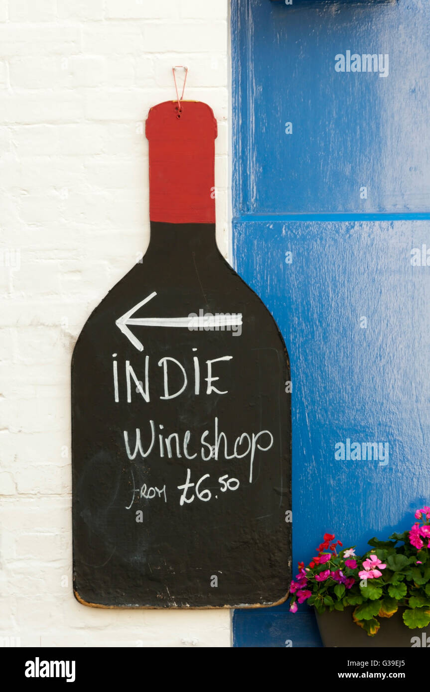 A sign for an independent wineshop, in the shape of a bottle. Stock Photo