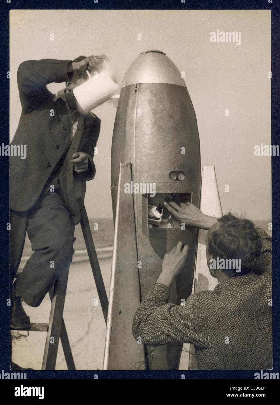 German rocket experiments on a windswept spit of land -  filling the device with its  chemical fuel       Date: 1930s Stock Photo