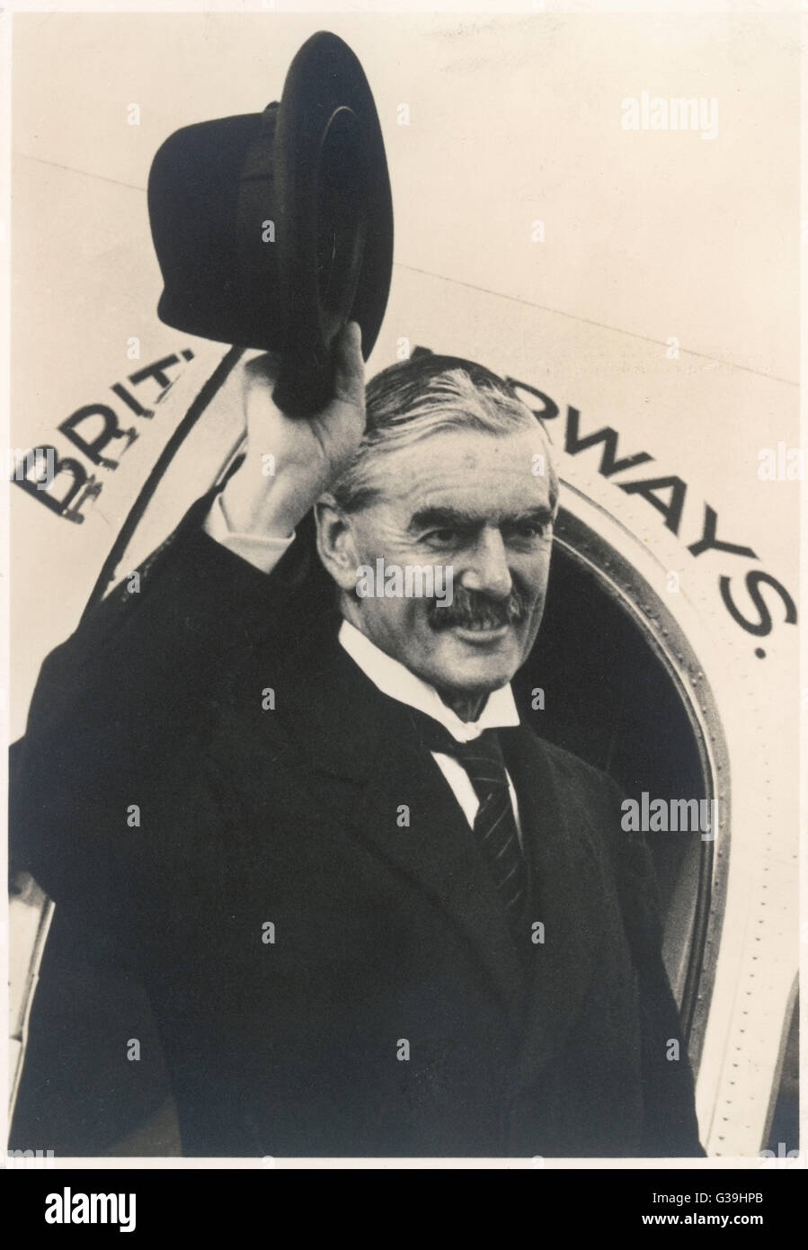 British Prime Minister, Neville Chamberlain (1869-1940), waves goodbye as he boards an airplane at Heston Airport on his way to Bad Godesberg, Germany to meet Adolf Hitler, for the second time, to hold talks regarding the Sudetenland. Chamberlain's policy Stock Photo