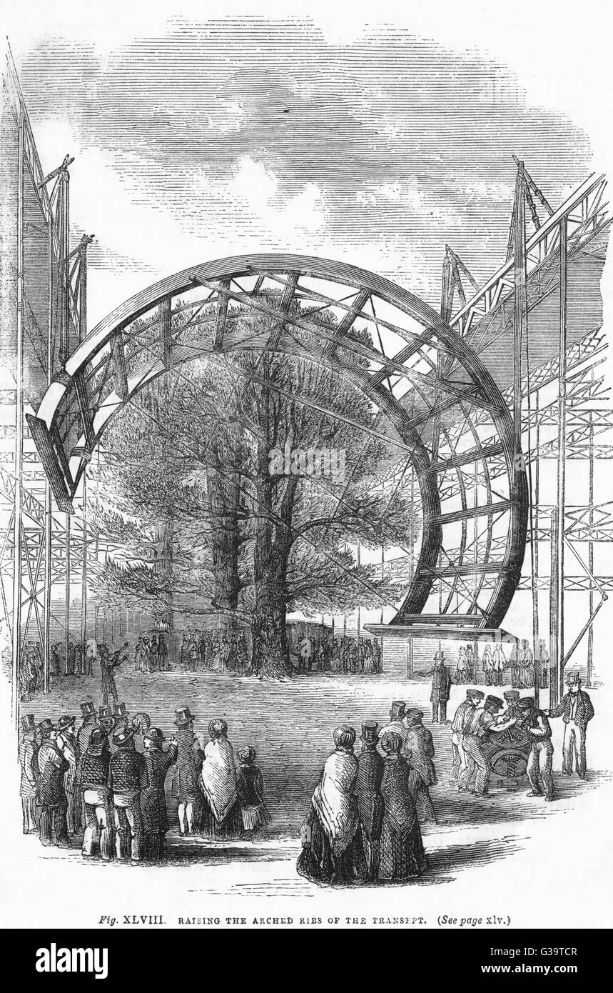One of the massive arched ribs of the transept is raised into position above the main Great  Exhibition building at Hyde  Park.      Date: 1851 Stock Photo