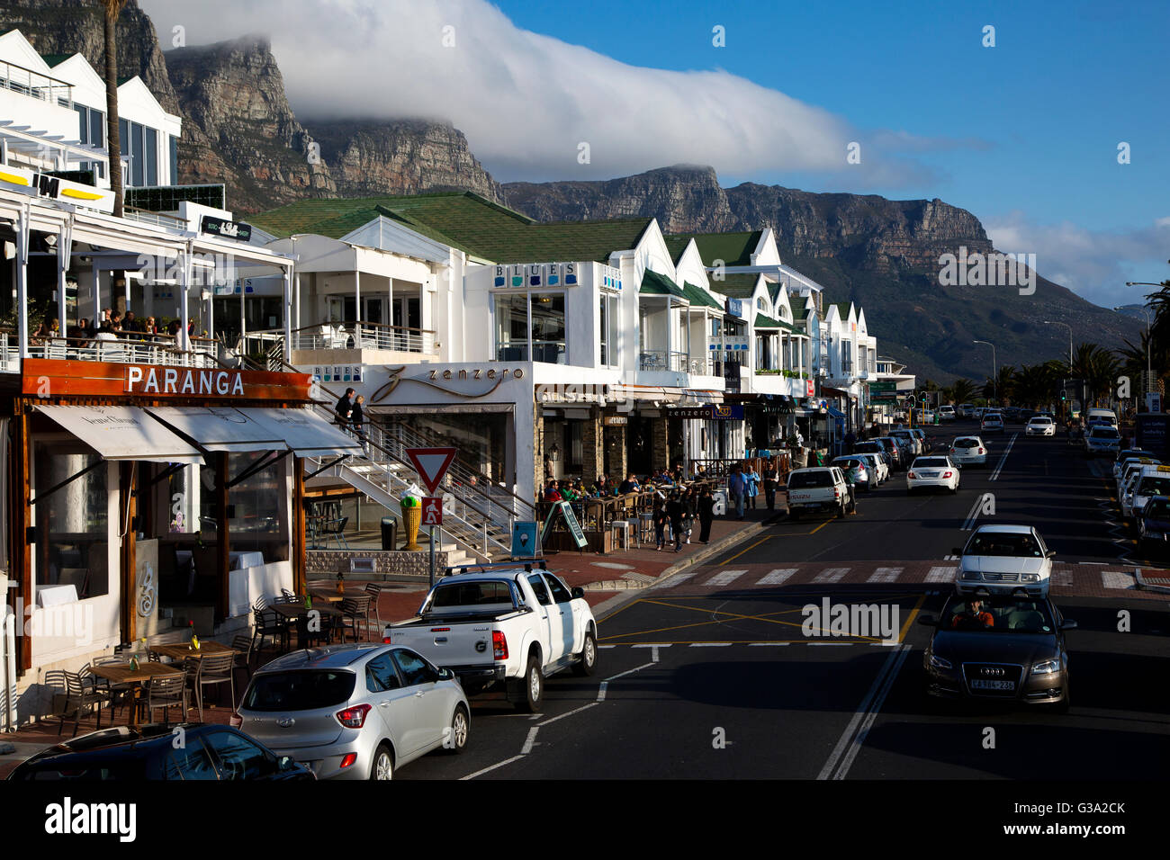 Street scene at Victoria Road, Camps Bay Beach, with table mountains in the background, Capetown, South Africa Stock Photo