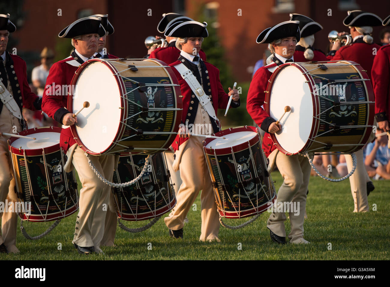 WASHINGTON DC, United States — The U.S. Army Fife and Drum Corps, dressed in Revolutionary War-era uniforms, performs during the Army Twilight Tattoo at Joint Base Myer-Henderson Hall. The musicians, playing traditional fifes and drums, demonstrate historical military music as part of this free, public pageant showcasing the U.S. Army's history and traditions. Stock Photo