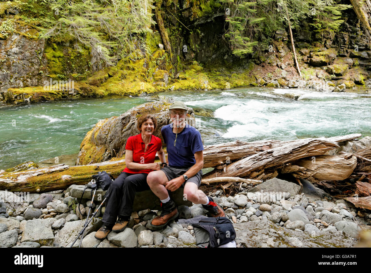 41,795.08221 Man and woman sitting on a rock in a canyon beside the ...