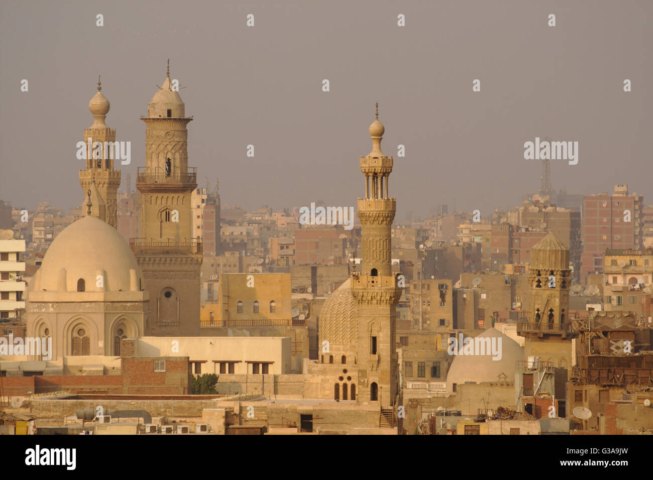 Minarets and domes of Qalawun complex, Barquq complex and Mosque of al-Ashraf Barsbey, evening, from minaret Bab Zuweila, Cairo Stock Photo