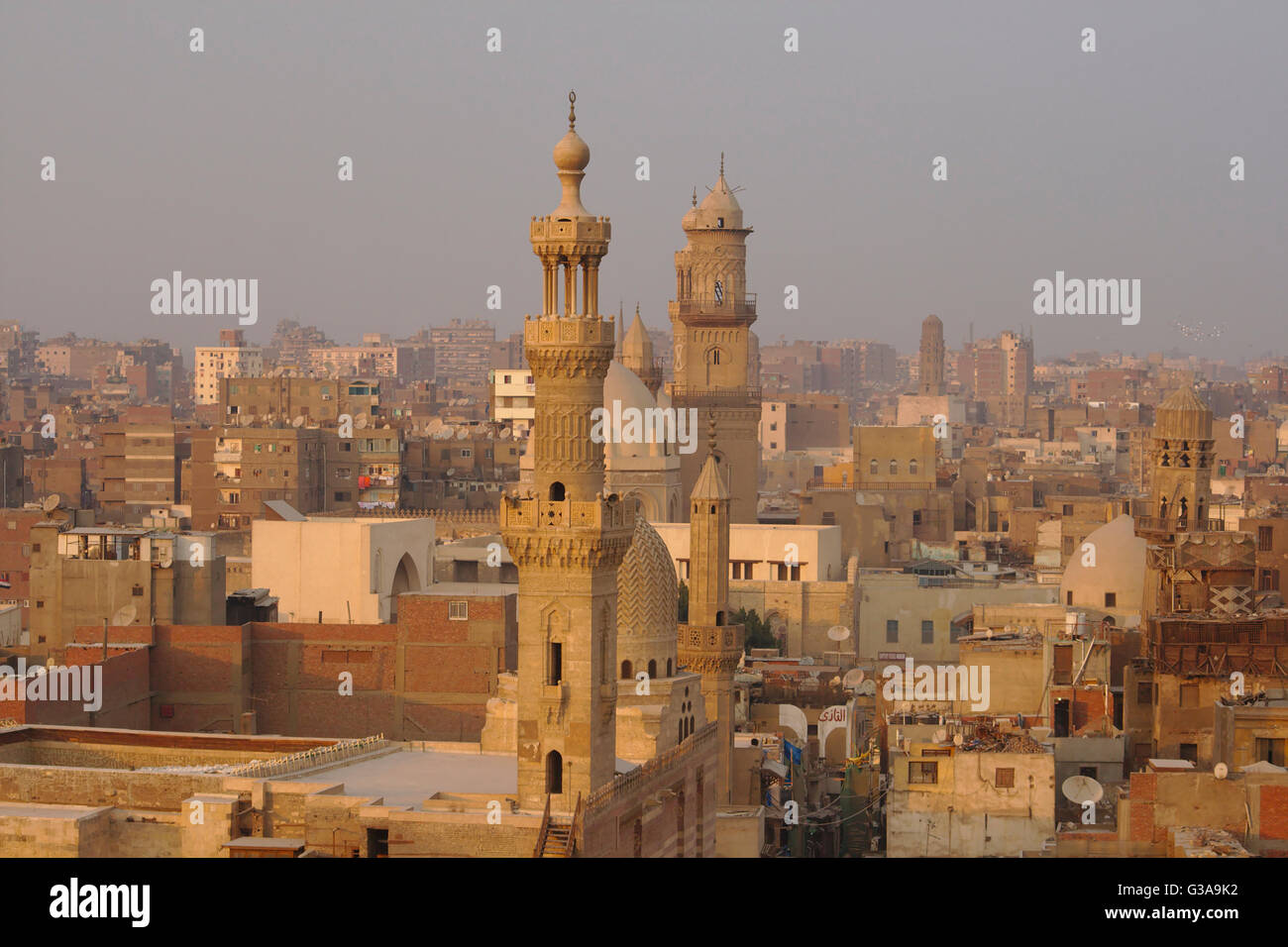 Cairo, al-Muizz li-Din Allah street, Mosque of al-Ashraf Barsbey and Qalawun Complex seen from the minaret of Al-Ghouri, evening Stock Photo