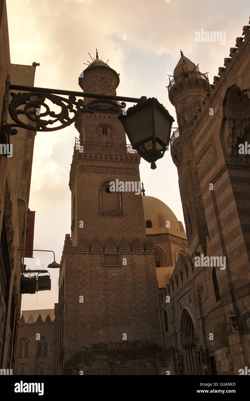 Cairo, Minaret and dome of Qalawun complex, minaret of Madrasa al-Nasir Muhammmad, portal of Barquq complex, dusk, Egypt Stock Photo