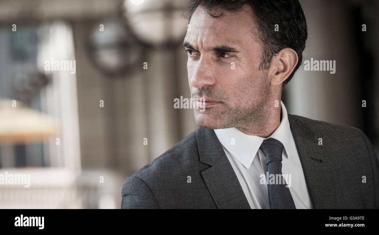 Close up pensive corporate businessman looking away Stock Photo
