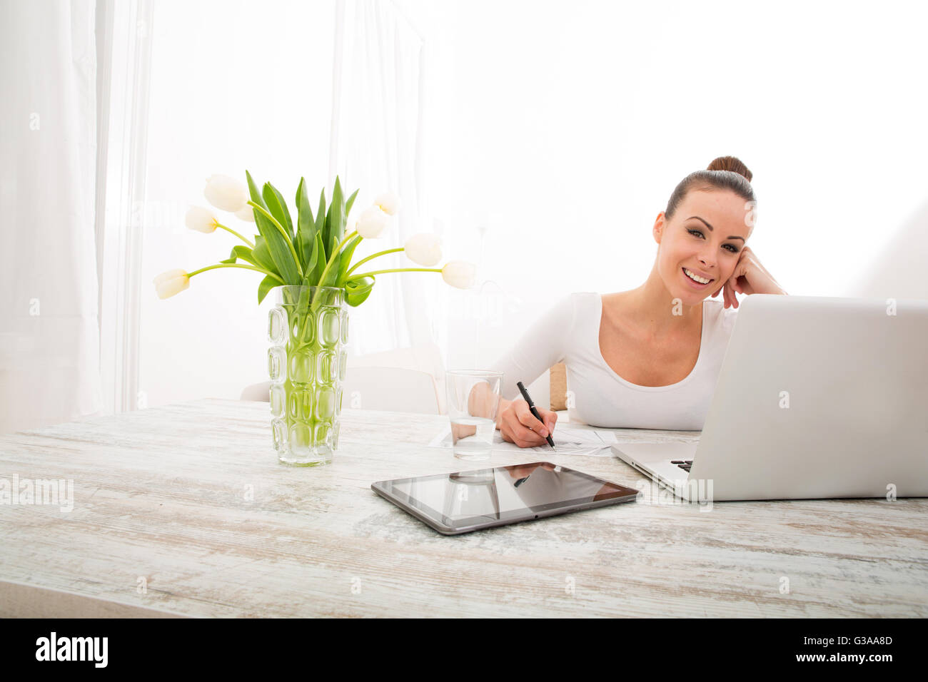 A young woman working from home with a laptop computer Stock Photo - Alamy