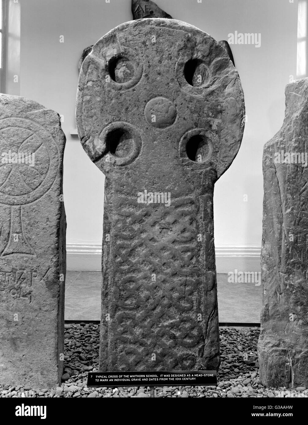 Whithorn Priory Museum, Wigtown: C10th Anglian headstone (7). Circular head, central boss, expanded-armed cross, sunken armpit circles. Stock Photo
