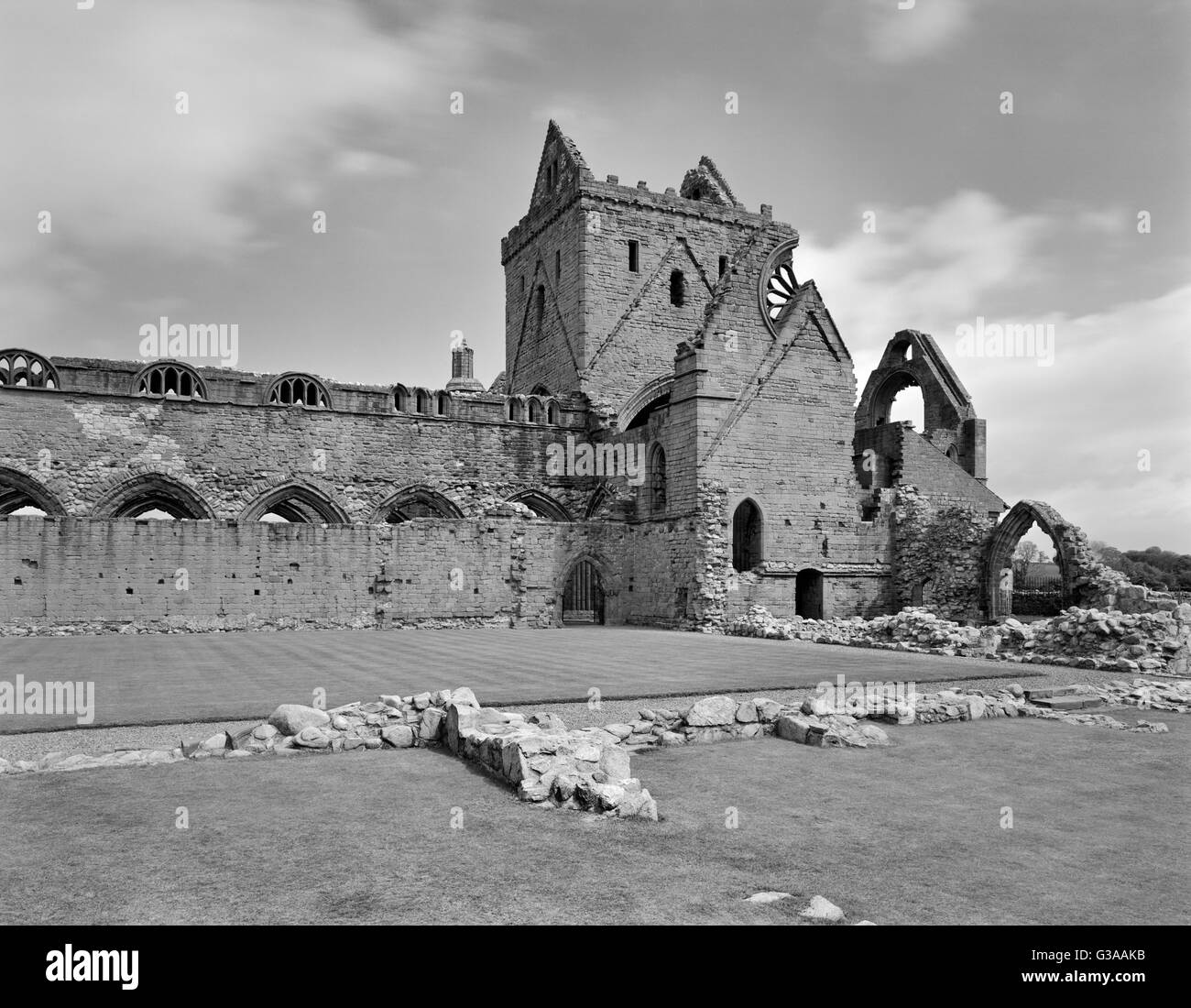 View NE across cloisters of Sweetheart Abbey, Dumfries, to the crossing-tower, chancel, S transept & part of the nave of the abbey church. Stock Photo