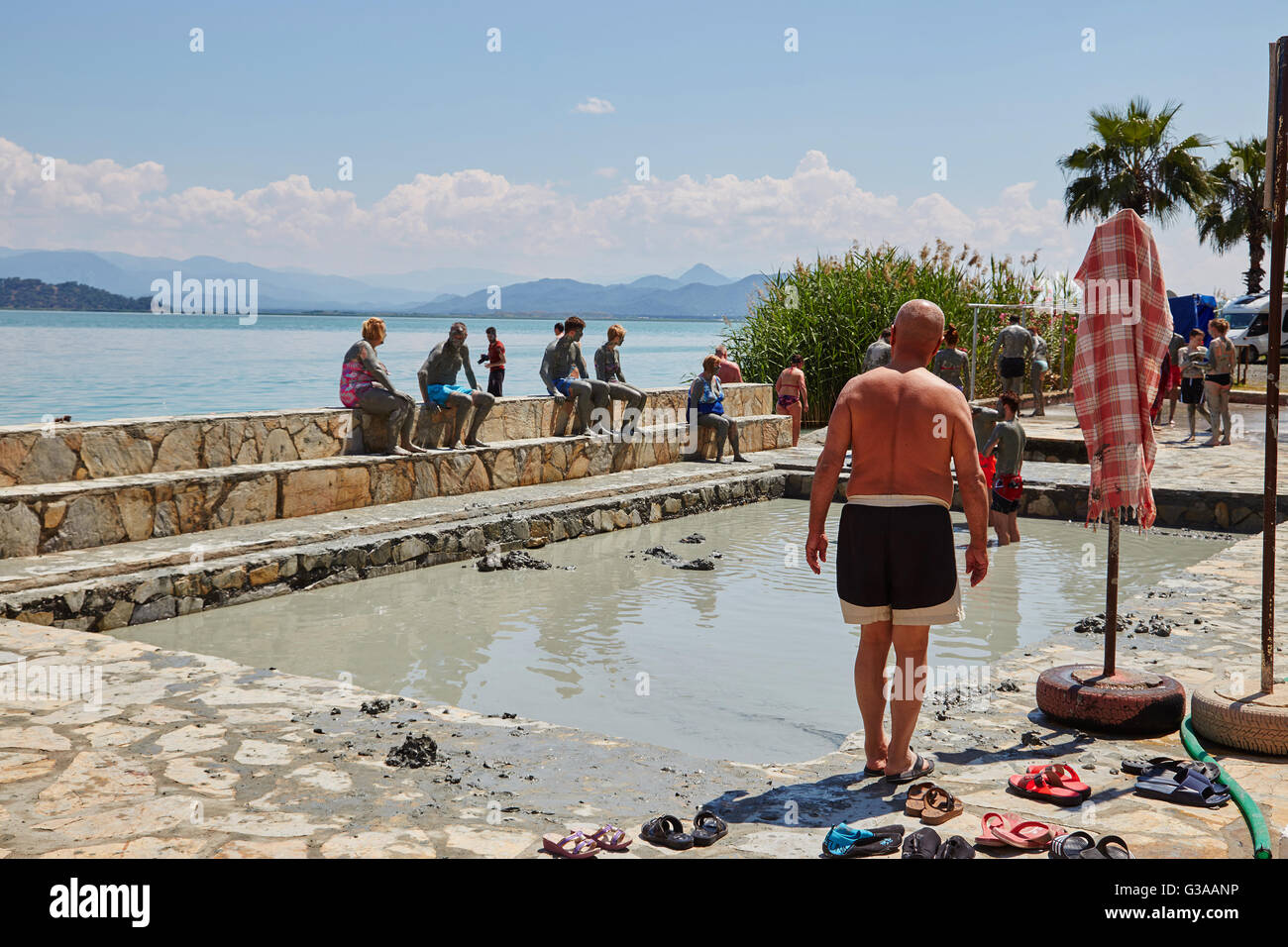 People taking a mud bath, thermal spa on Lake Koycegiz, Sultaniye, near Dalyan, Mugla Province, Turkey. Stock Photo