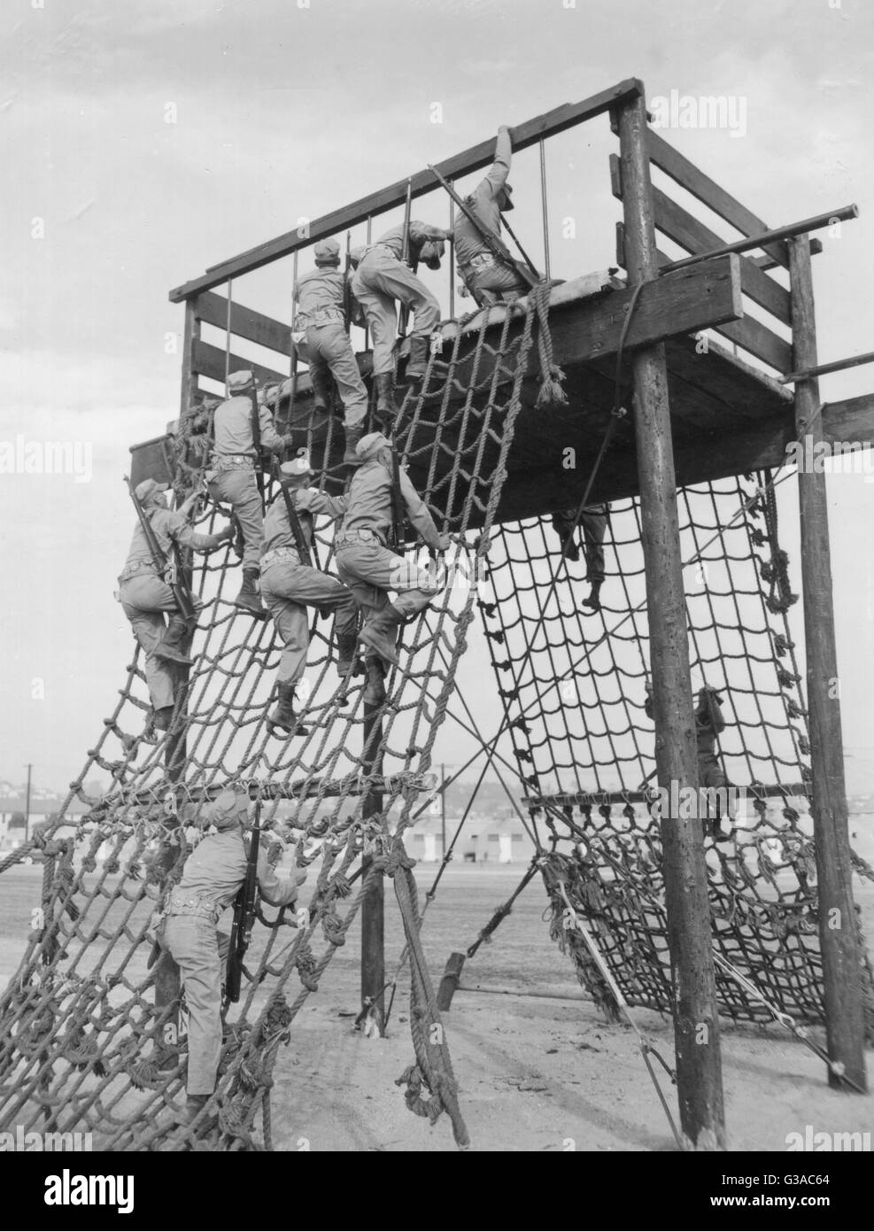 Recruits at Marine Corps Recruit Depot, San Diego, CA, are shown going over one of the many obstacles which have recently been erected on the depot as part of their boot training. Stock Photo