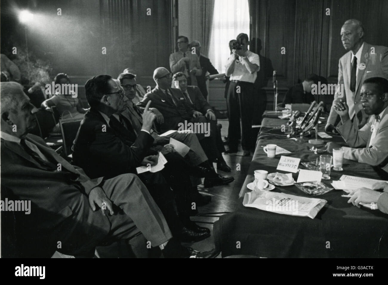 A. Philip Randolph (standing right), African-American labor leader and originator of the 'March on Washington' idea, and Cleveland Robinson (seated right), chairman of the March administrative committee, answer questions posed by Congressional leaders at the Capitol in Washington. Randolph outlined in detail the plans for the August 28th demonstration march in support of President Kennedy's civil rights legislation. Stock Photo