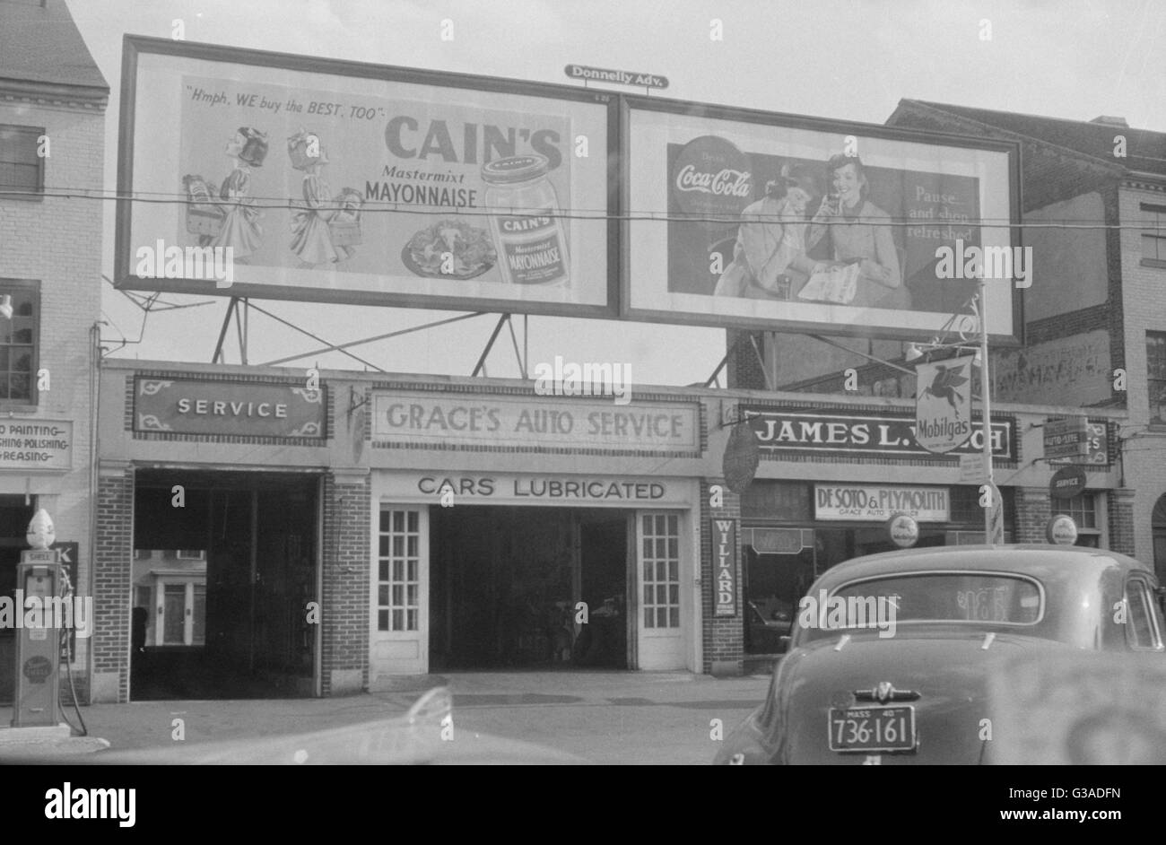 Garage and signs on street, Portsmouth, New Hampshire. Date 1940 Stock