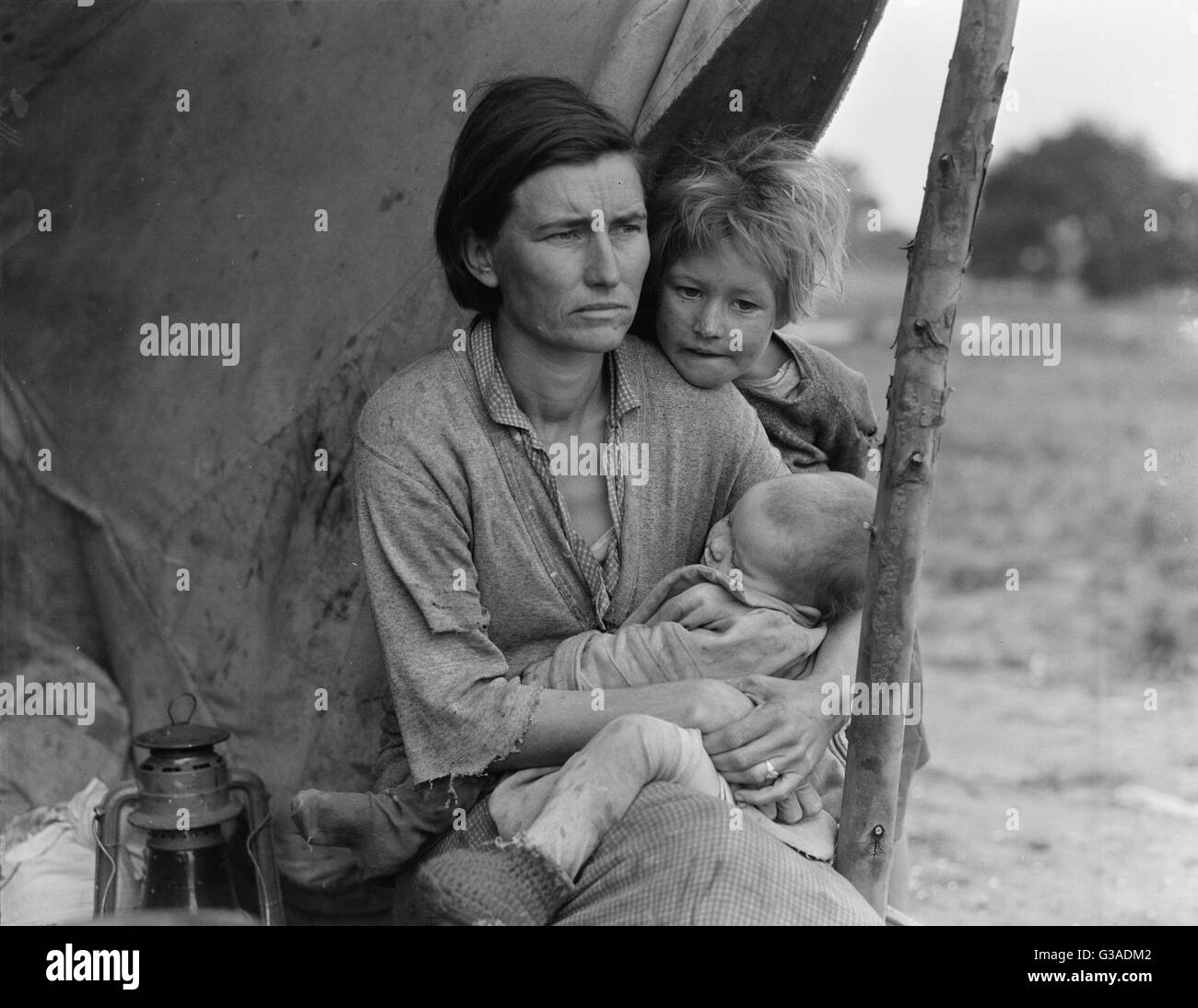 Migrant agricultural worker's family. Seven hungry children. Mother aged thirty-two. Father is a native Californian. Destitute in pea picker's camp, Nipomo, California, because of the failure of the early pea crop. These people had just sold their tent in Stock Photo