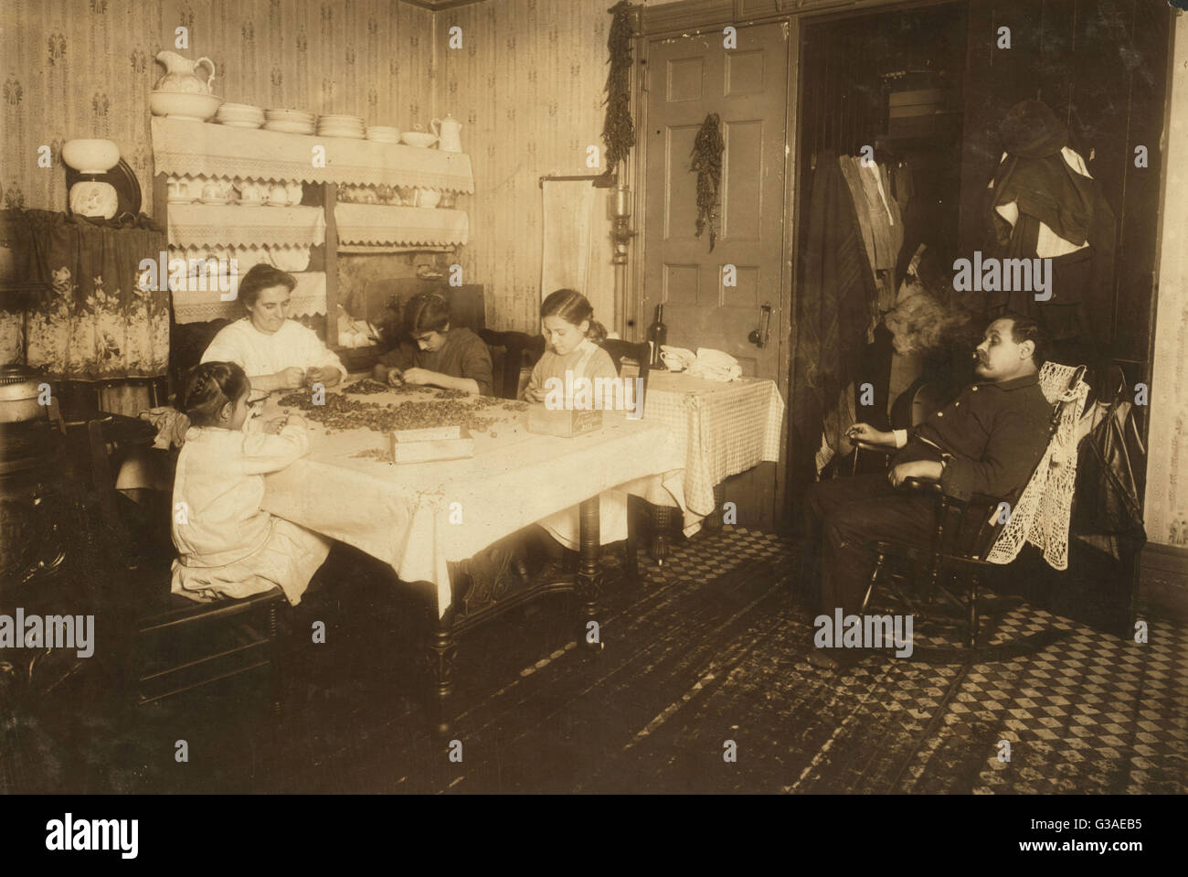 Everybody works but -  - . A common scene in the tenements. Stock Photo