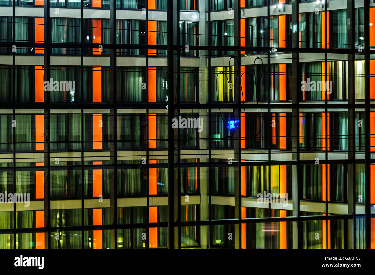 Illuminated night front of modern building Stock Photo - Alamy