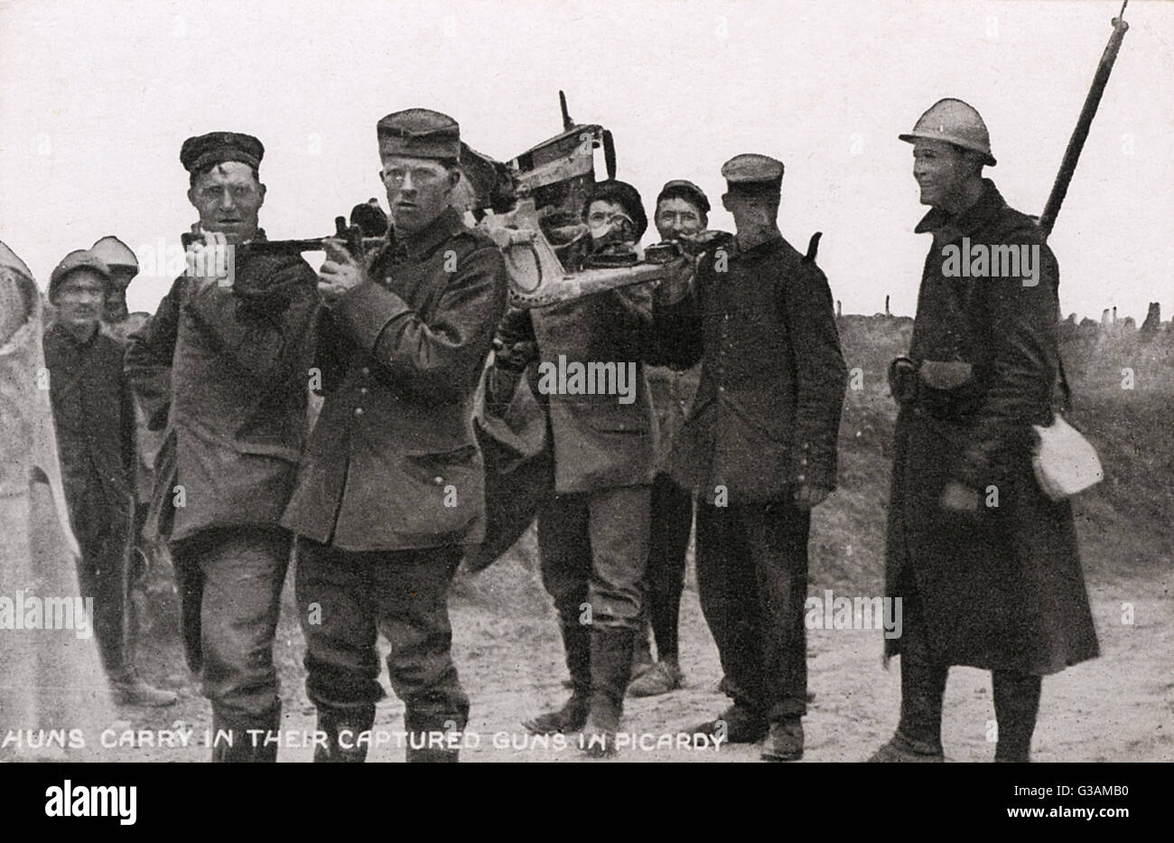 German prisoners made to carry their guns - WWI Stock Photo