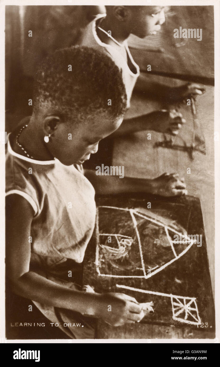 Young Ghanaian girl learning to draw Stock Photo