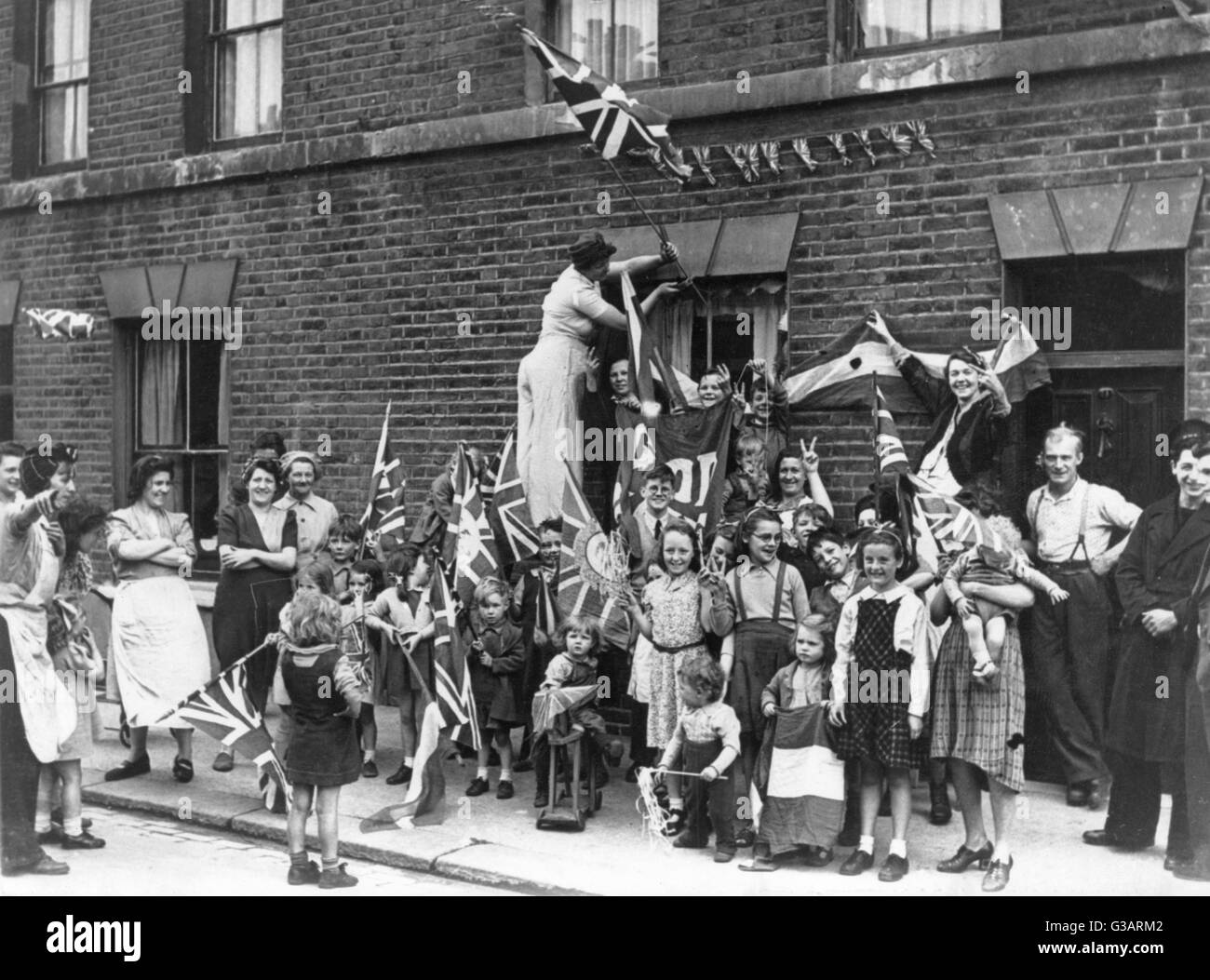 A street celebration with flags in Battersea, South London, to celebrate the end of the Second World War on VE Day.      Date: 1945 Stock Photo