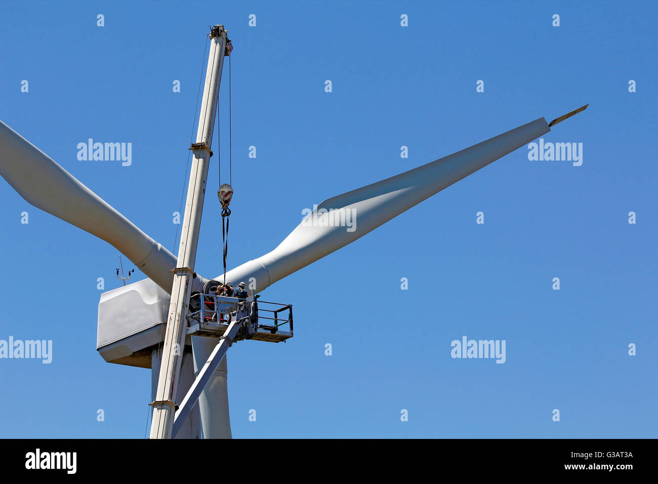 Wind turbine being repaired, assisted by crane and elevator Stock Photo