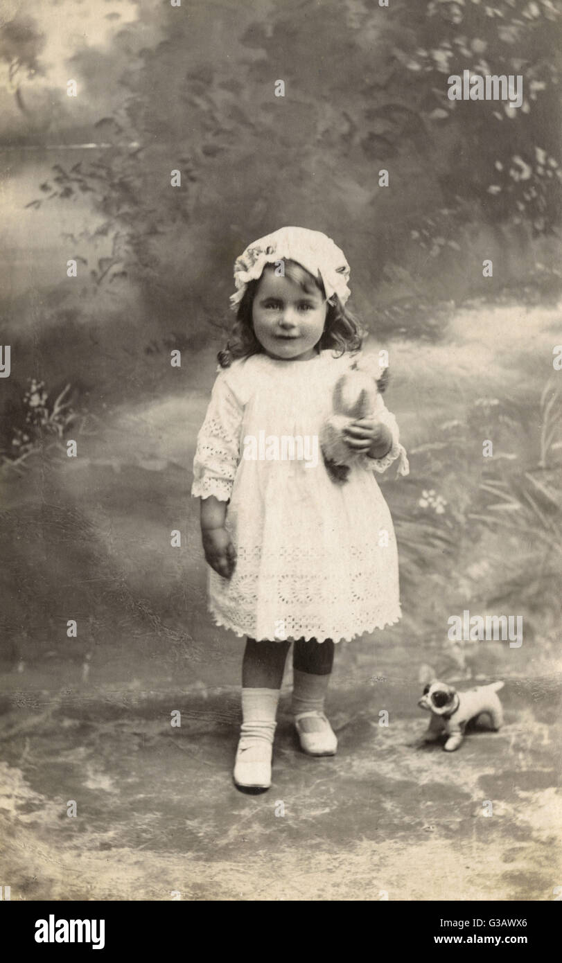 Studio portrait, little girl with toy bulldog Stock Photo Alamy