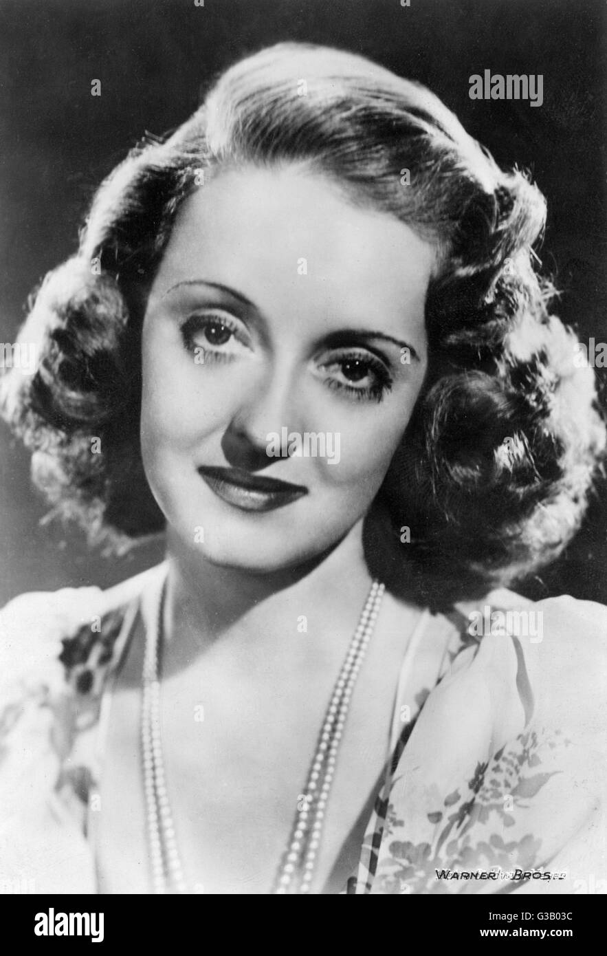 BETTE DAVIS American film actress wearing a pearl necklace Date: 1908 ...