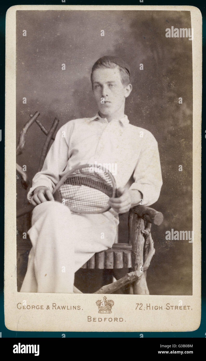 A Superior Looking Young Man Sits On A Rustic Style Chair In