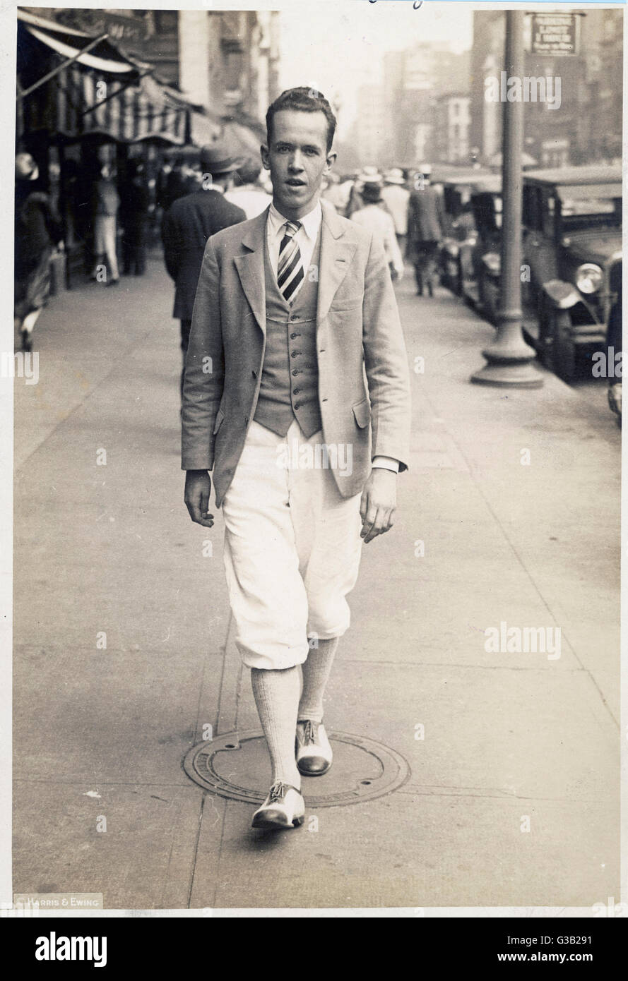 19 year old American in light  coloured plus-fours, woollen  socks &amp; co-respondent shoes,  waistcoat, single-breasted  jacket &amp; tie probably in a British regimental stripe.     Date: 1927 Stock Photo