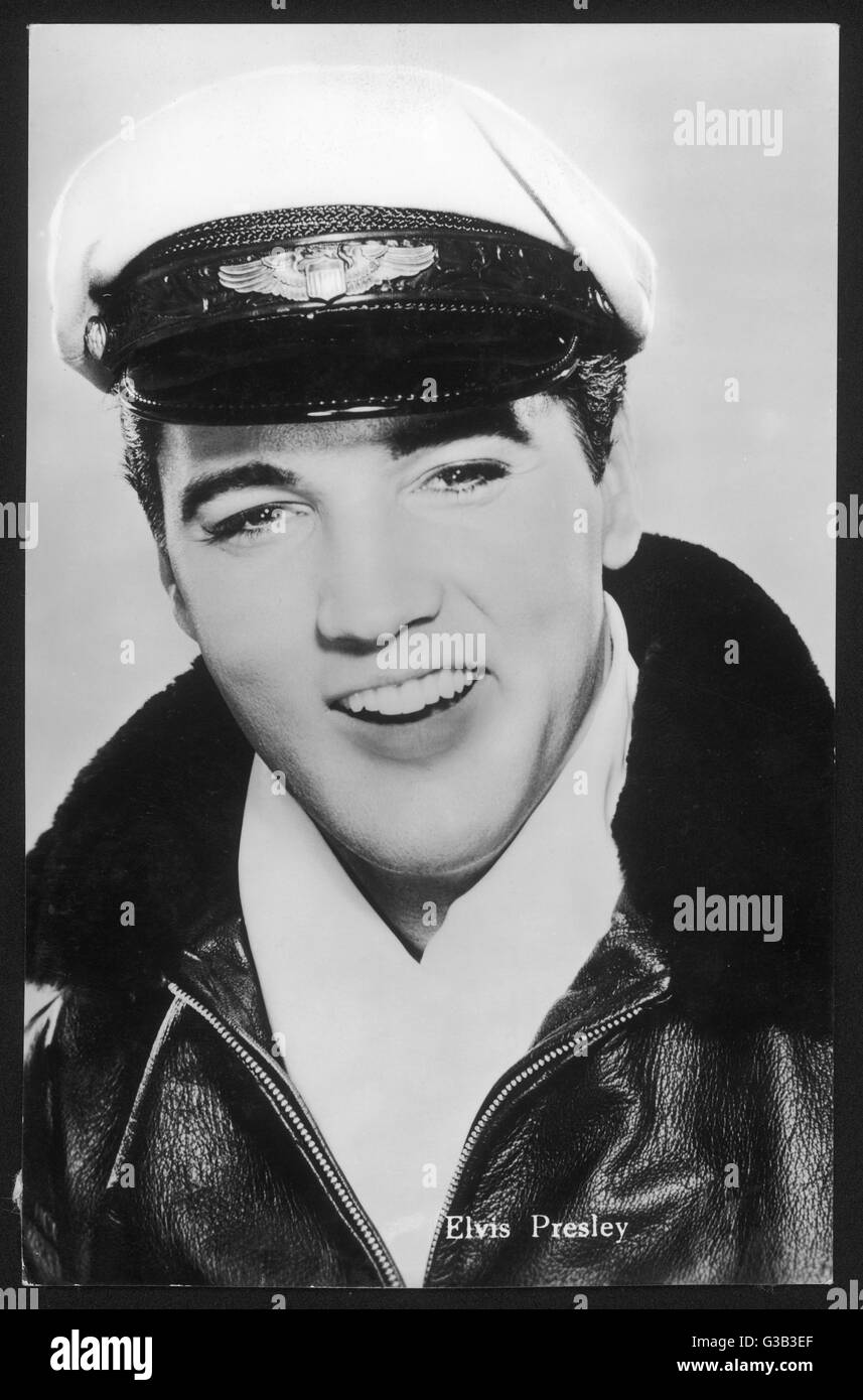 ELVIS PRESLEY  American pop singer, guitarist  and actor in musical films,  seen here in a leather jacket and peaked cap     Date: 1935 - 1977 Stock Photo