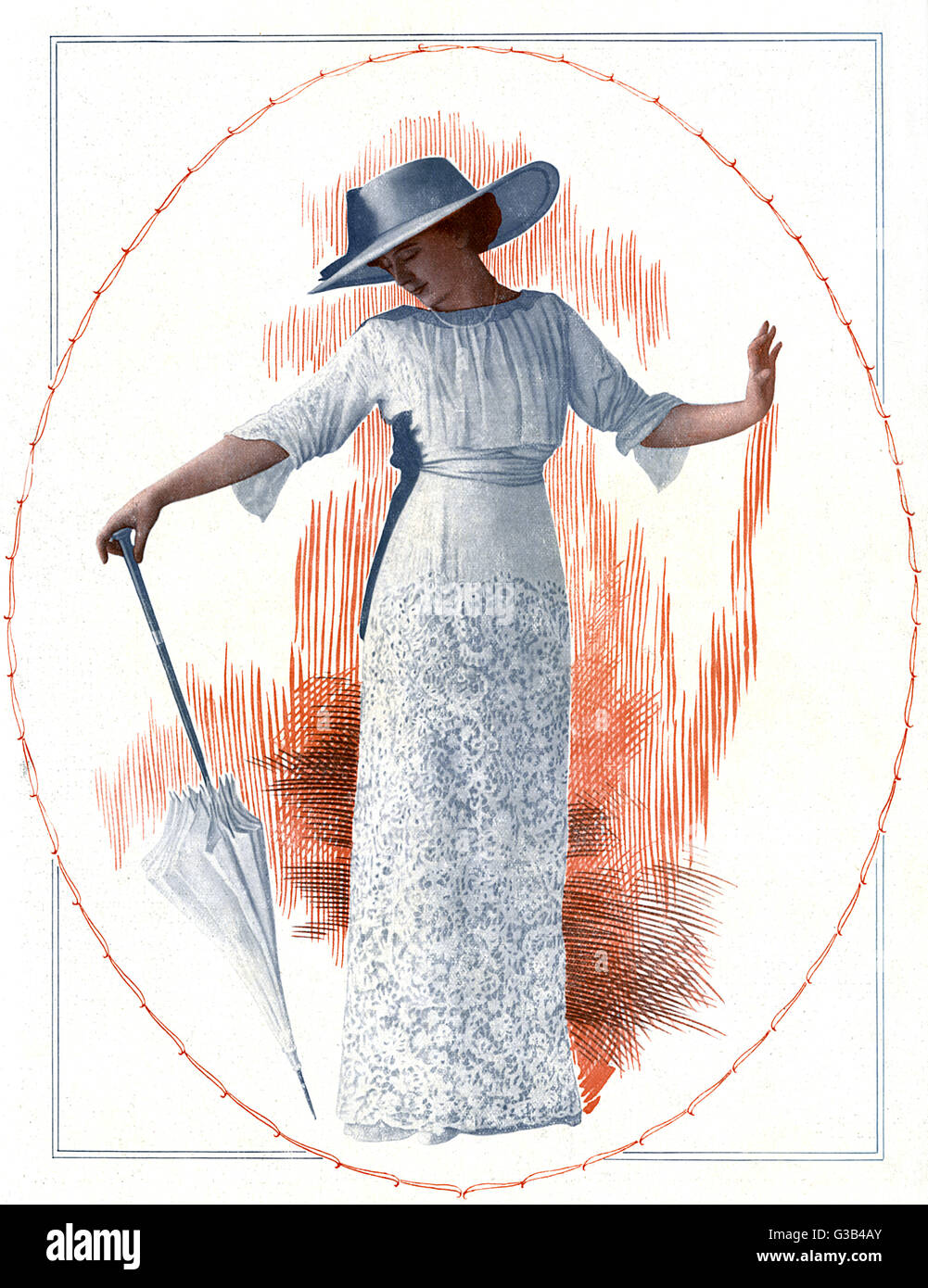 A garden party dress with a  high waist, gathered corsage,  sash belt &amp; heavily  embroidered skirt with a plain  yoke. Worn with a capeline hat  with a velvet hatband.  1912 Stock Photo