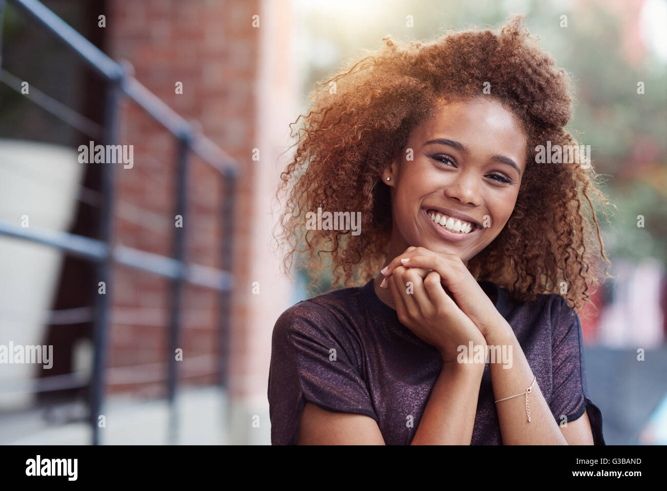 Content woman curly hair hi-res stock photography and images - Alamy