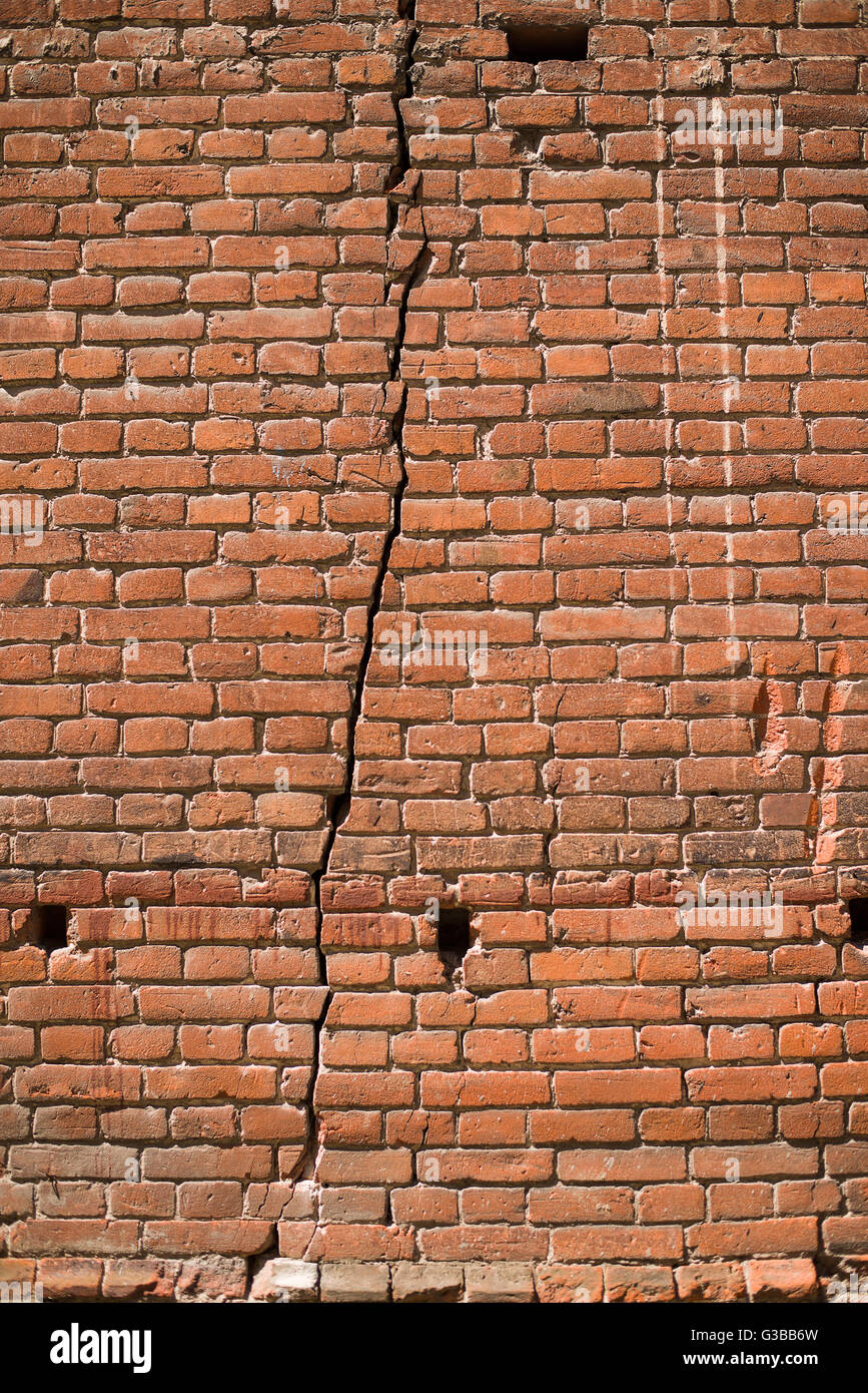 A crack in the wall of the old brick house Stock Photo