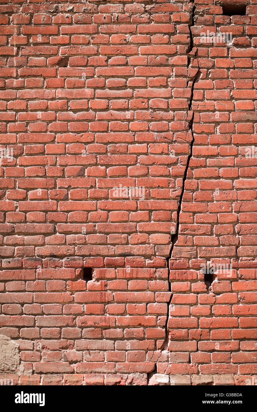 A crack in the wall of the old brick house Stock Photo