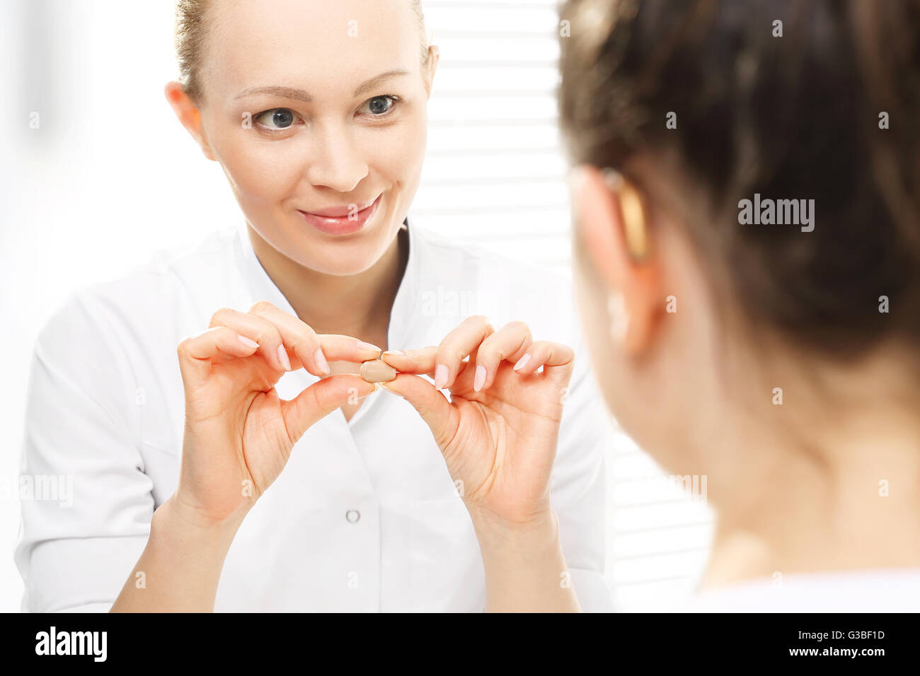 Doctor otolaryngologist with the hearing aid Stock Photo Alamy