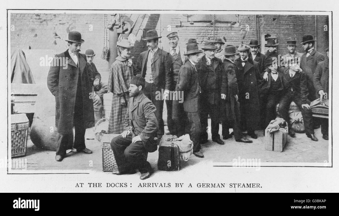 At the docks: arrivals by a  German steamer; men and women,  some Jewish, wait on dockside  having travelled by boat from  Germany     Date: 1900 Stock Photo