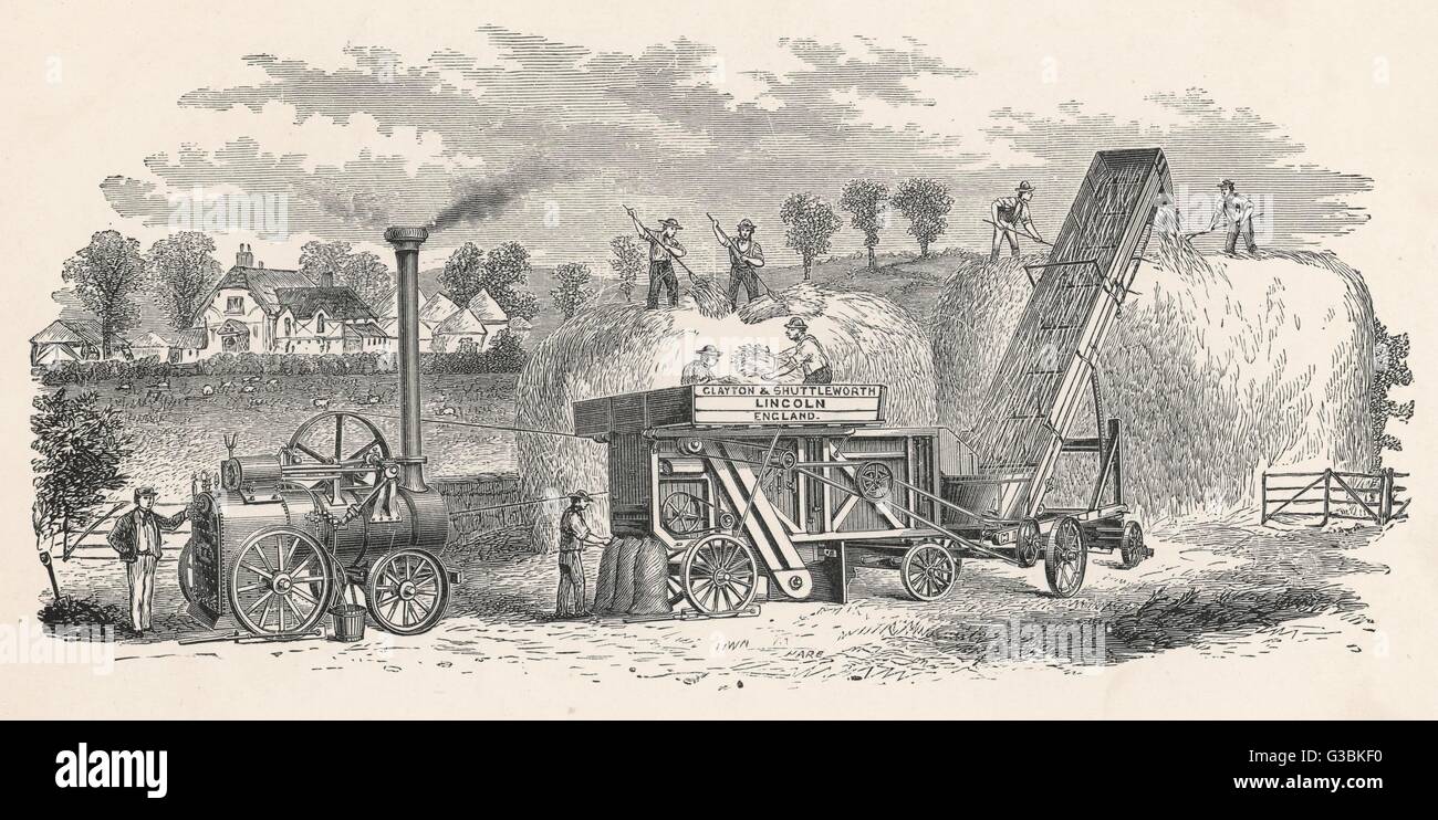 Rick-making machine by Clayton  &amp; Shuttleworth of Lincoln,  powered by an elegant steam  engine.       Date: 1880 Stock Photo