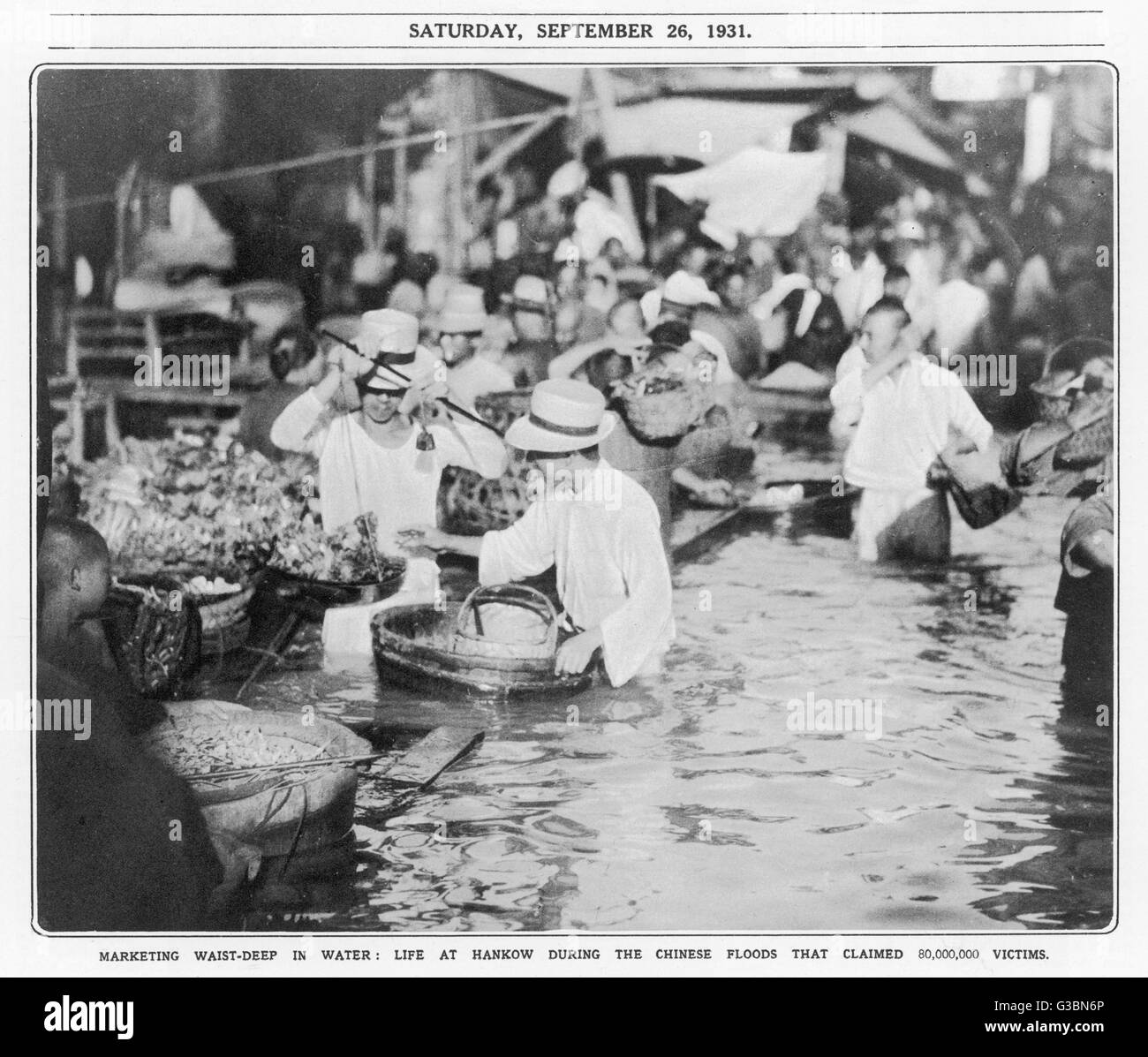 Marketing waist-deep in water,  life at Hankow during the  flood from the Yangtze river        Date: 26 September 1931 Stock Photo