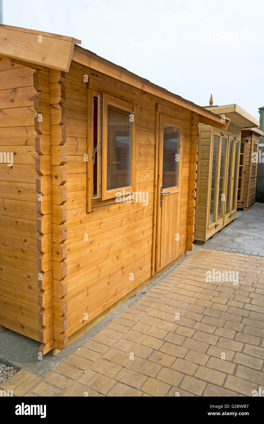 Tanalised timber workshop, home office or summer houses, of log lap construction, built of redwood or pine, Lancashire, UK Stock Photo