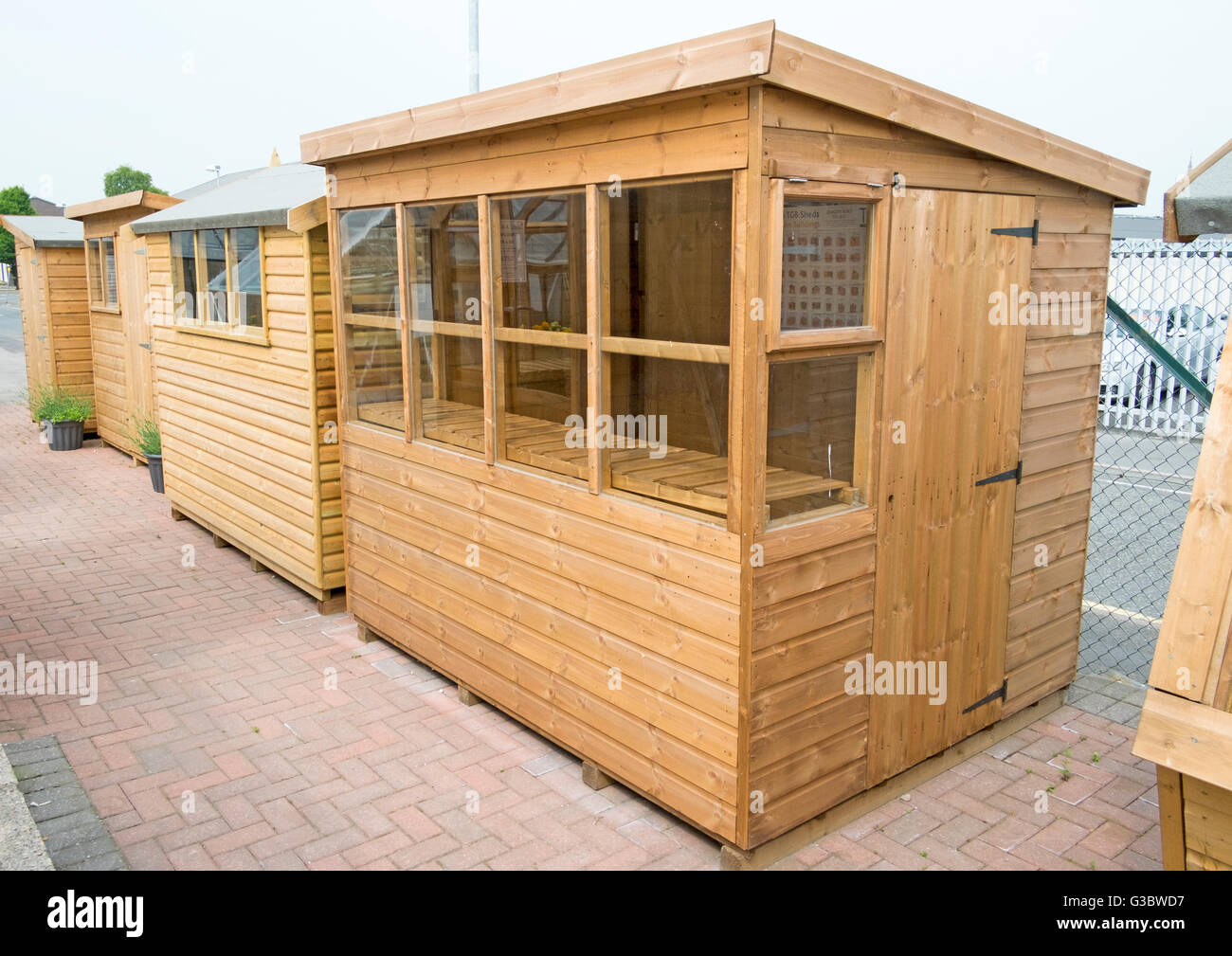 Tanalised timber workshop, home office or summer houses, of log lap construction, built of redwood or pine, Lancashire, UK Stock Photo