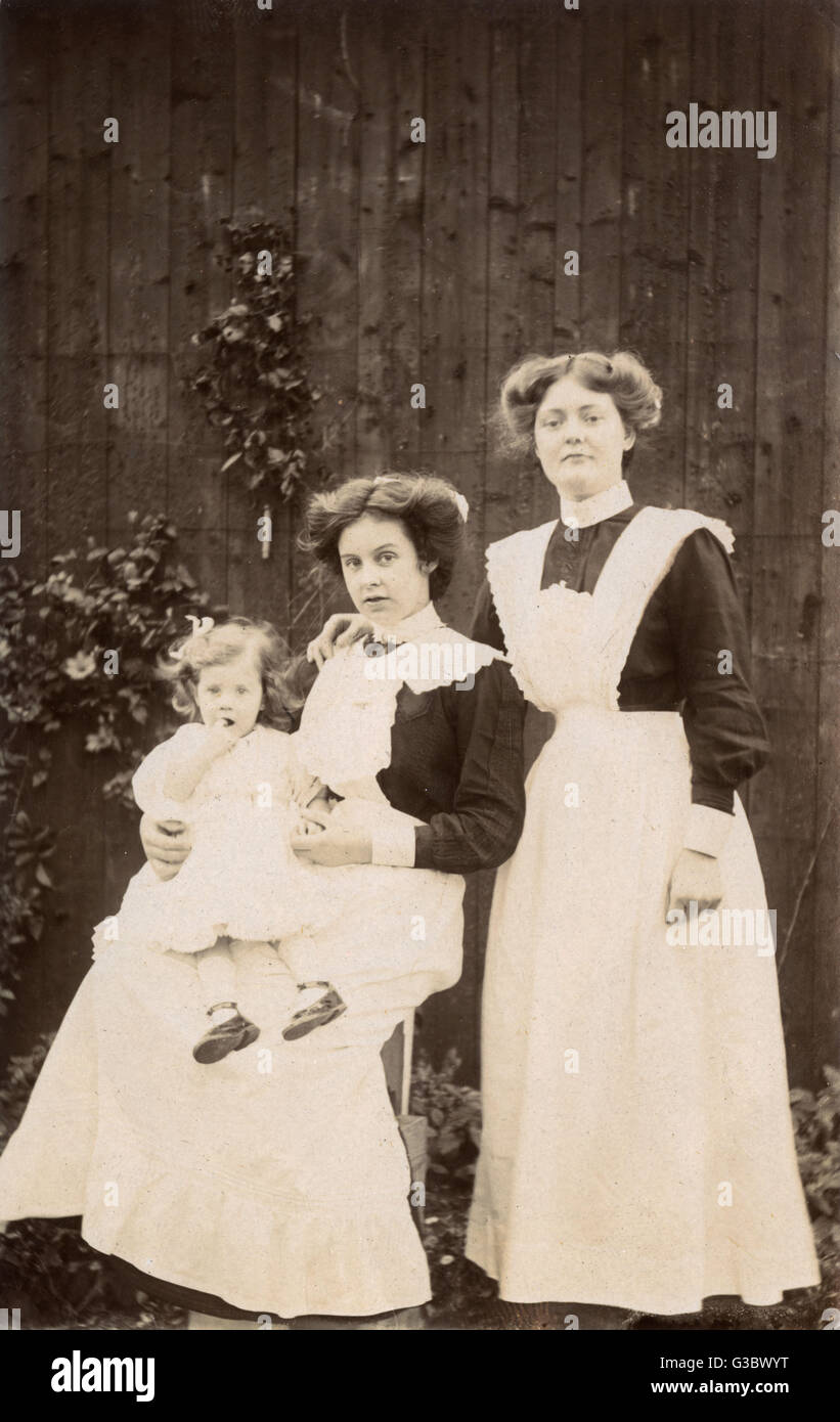 Two Housemaids and toddler - Edwardian England Stock Photo