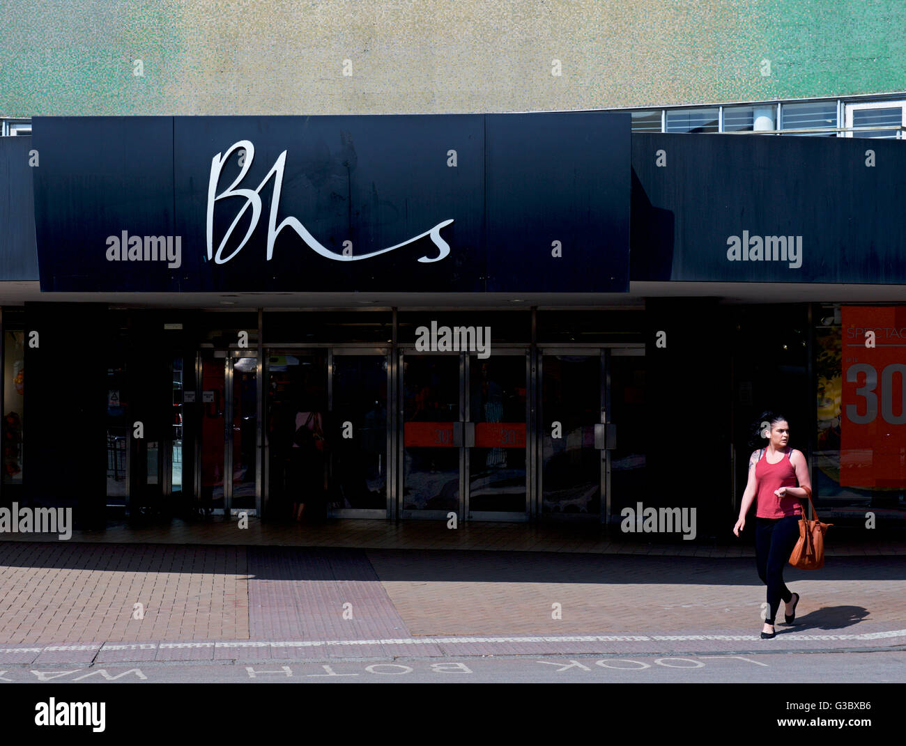 Young woman and branch of BHS department store, Kingston upon Hull, East Yorkshire, England UK Stock Photo