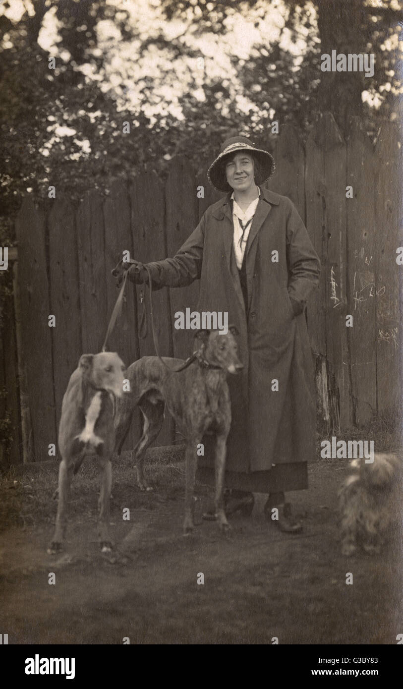 Woman and dogs in garden Stock Photo - Alamy