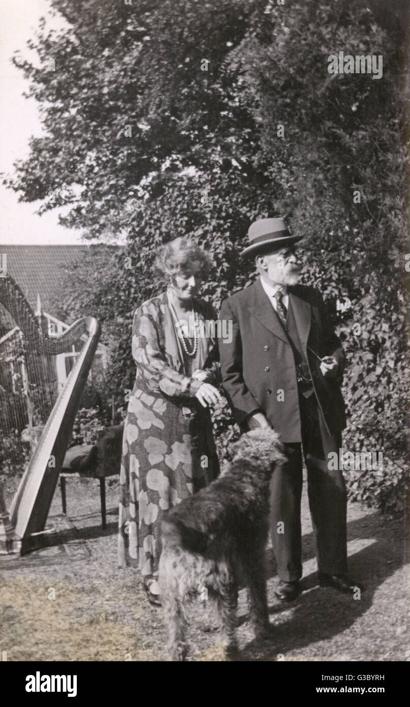 Couple with dog in the garden Stock Photo - Alamy