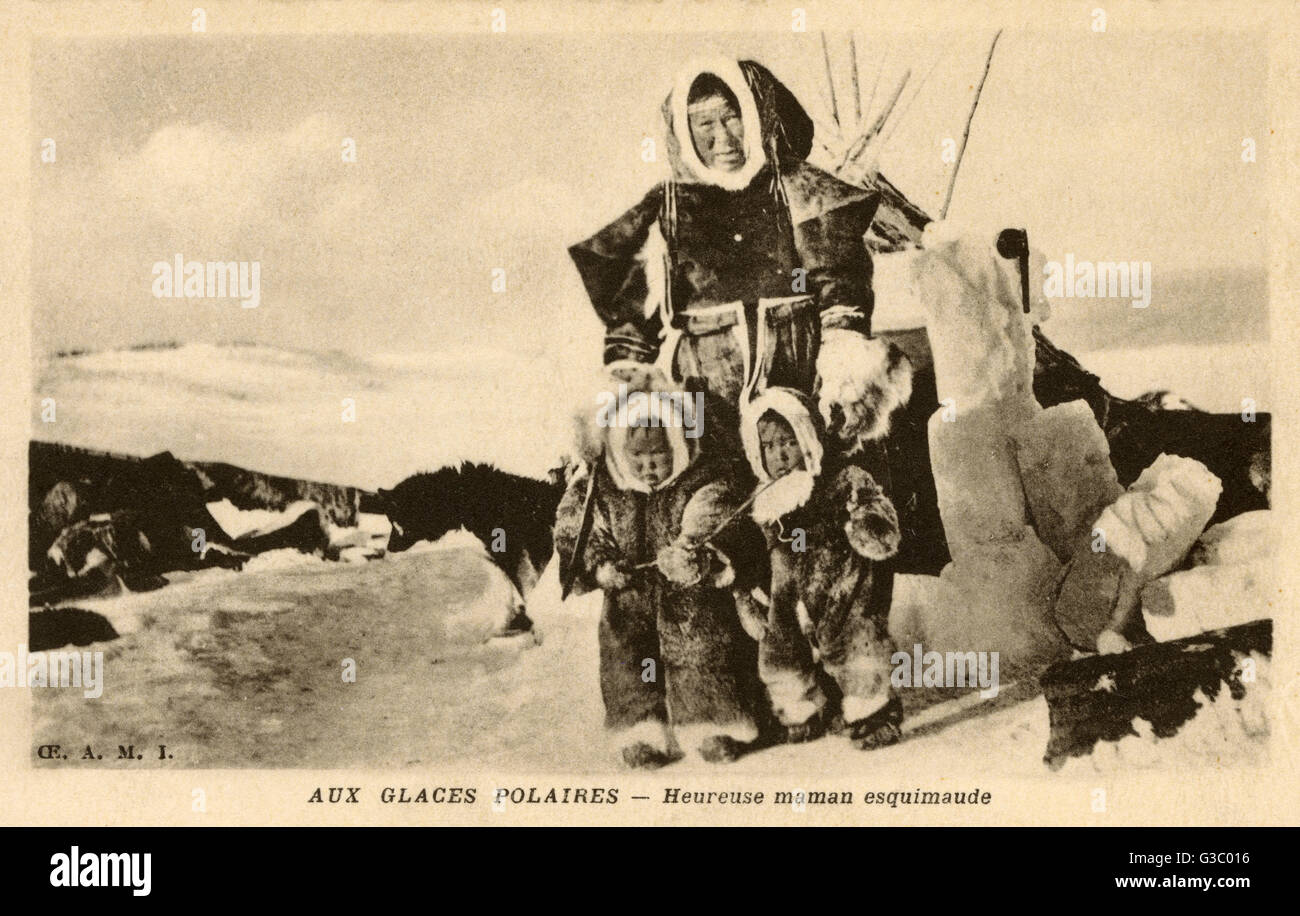 Inuit - Mother and Children on the Polar Ice by their tent, with block ice entrance.     Date: circa 1910s Stock Photo