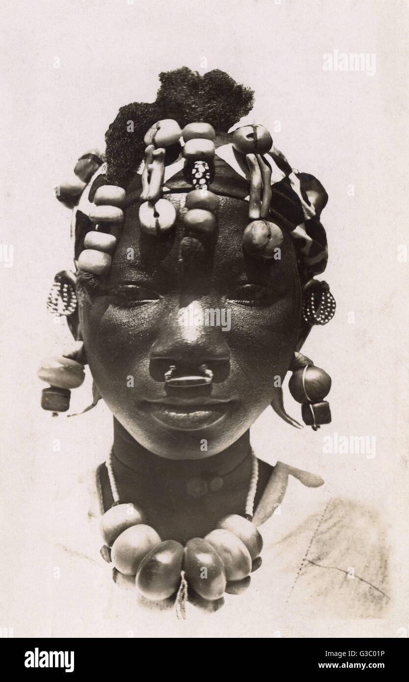 Young Soninke Girl from Mali wearing wonderful beads and beaded headdress. The Soninke (also called Sarakole, Seraculeh, or Serahuli) are a Mande people who descend from the Bafour and are closely related to the Imraguen of Mauritania.     Date: circa 193 Stock Photo