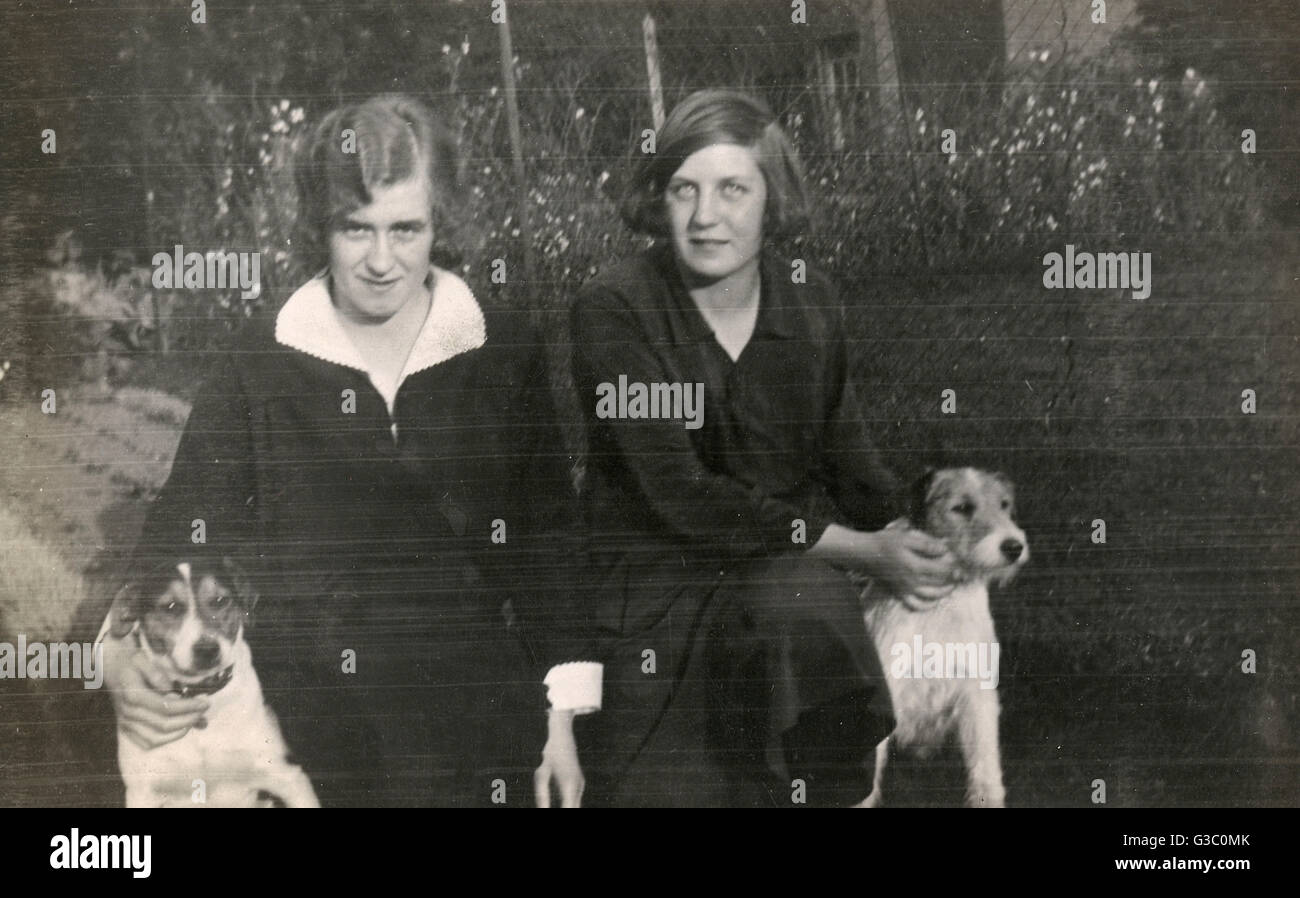 Two women and two terriers in a garden Stock Photo - Alamy