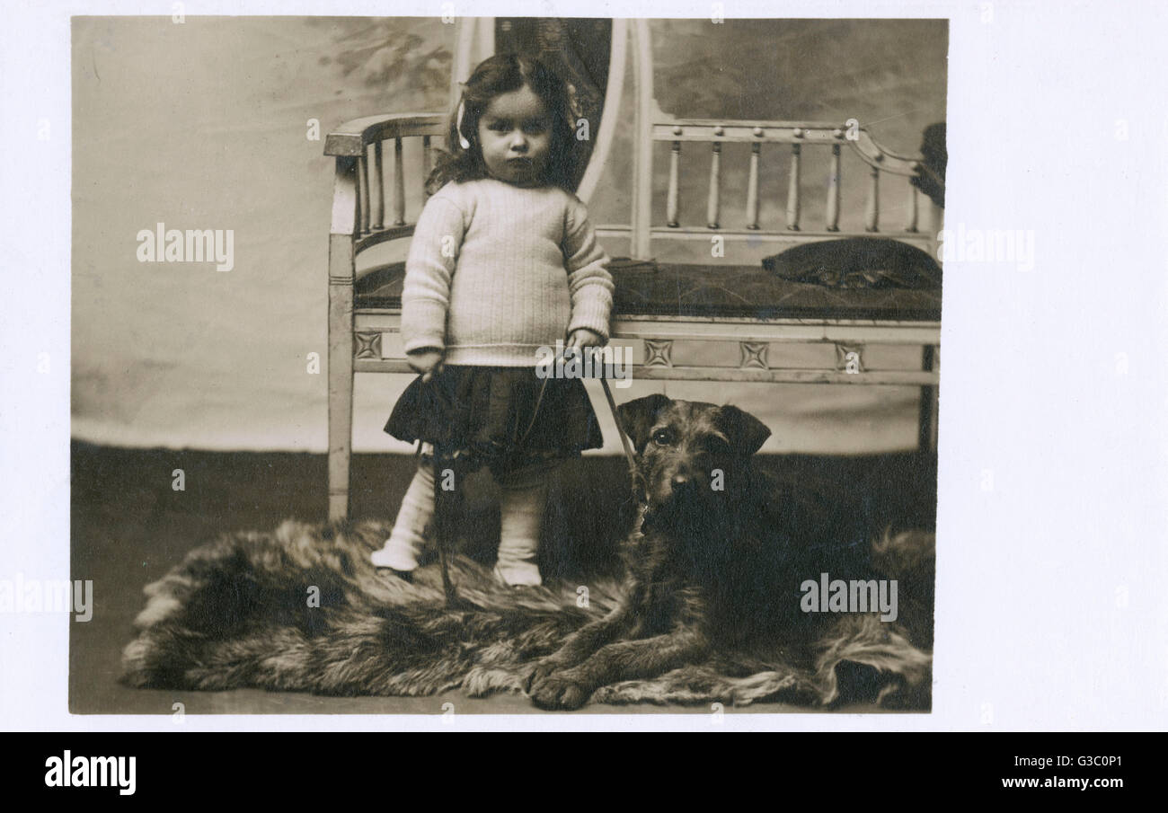 Studio portrait of little girl and dog Stock Photo - Alamy