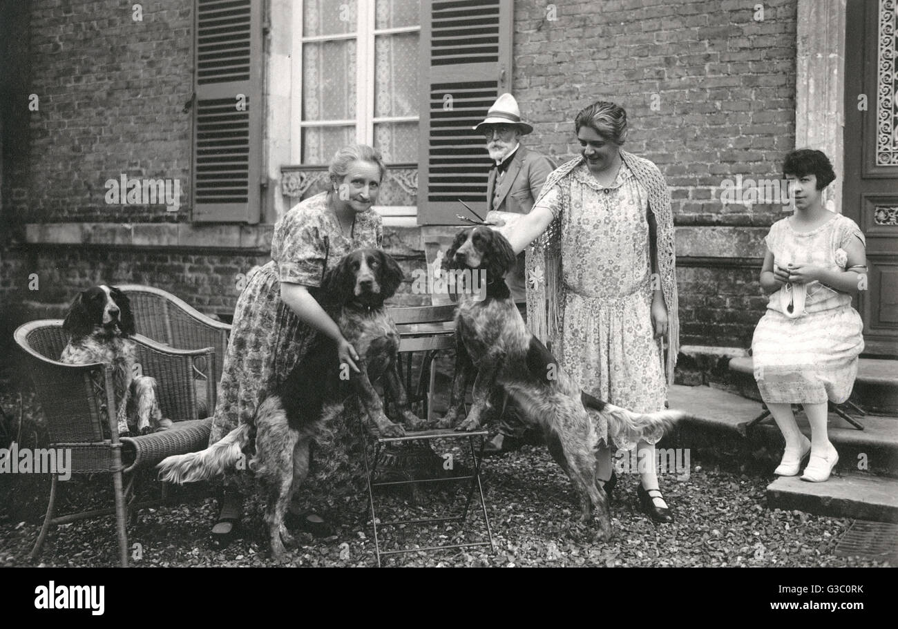 People with three dogs in a garden, France Stock Photo - Alamy